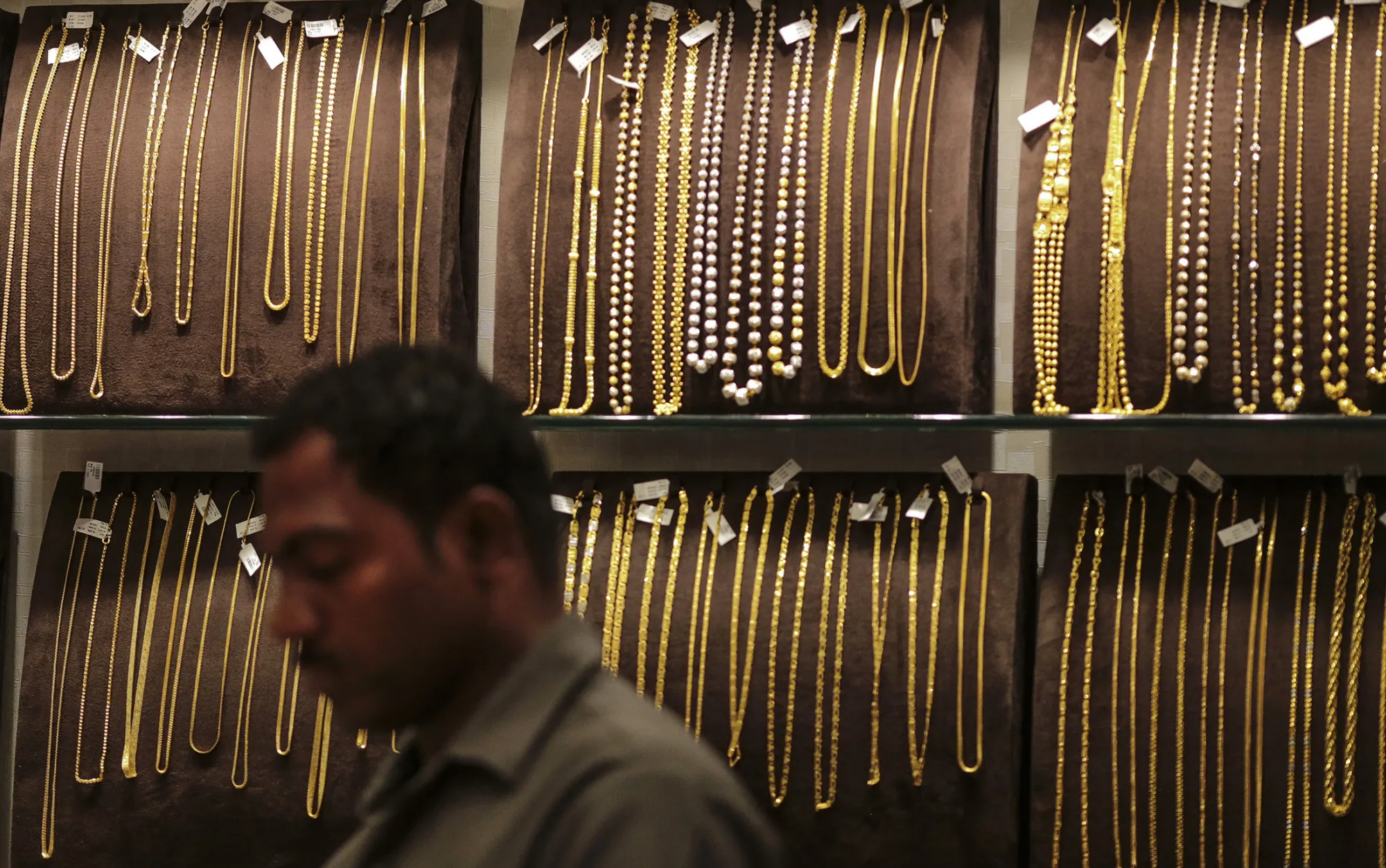 Gold chains and necklaces sit on display inside the Dwarkadas Chandumal Jewelers store in the Zaveri Bazaar area of Mumbai, India, on Tuesday, April 21, 2015.

