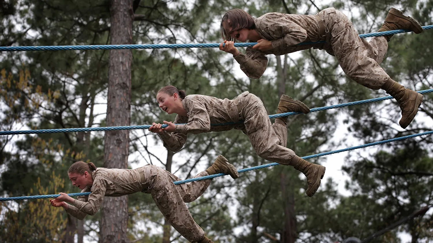 Female Marine recruits navigate an obstacle during boot camp on Feb. 27, 2013, at MCRD Parris Island, South Carolina.

