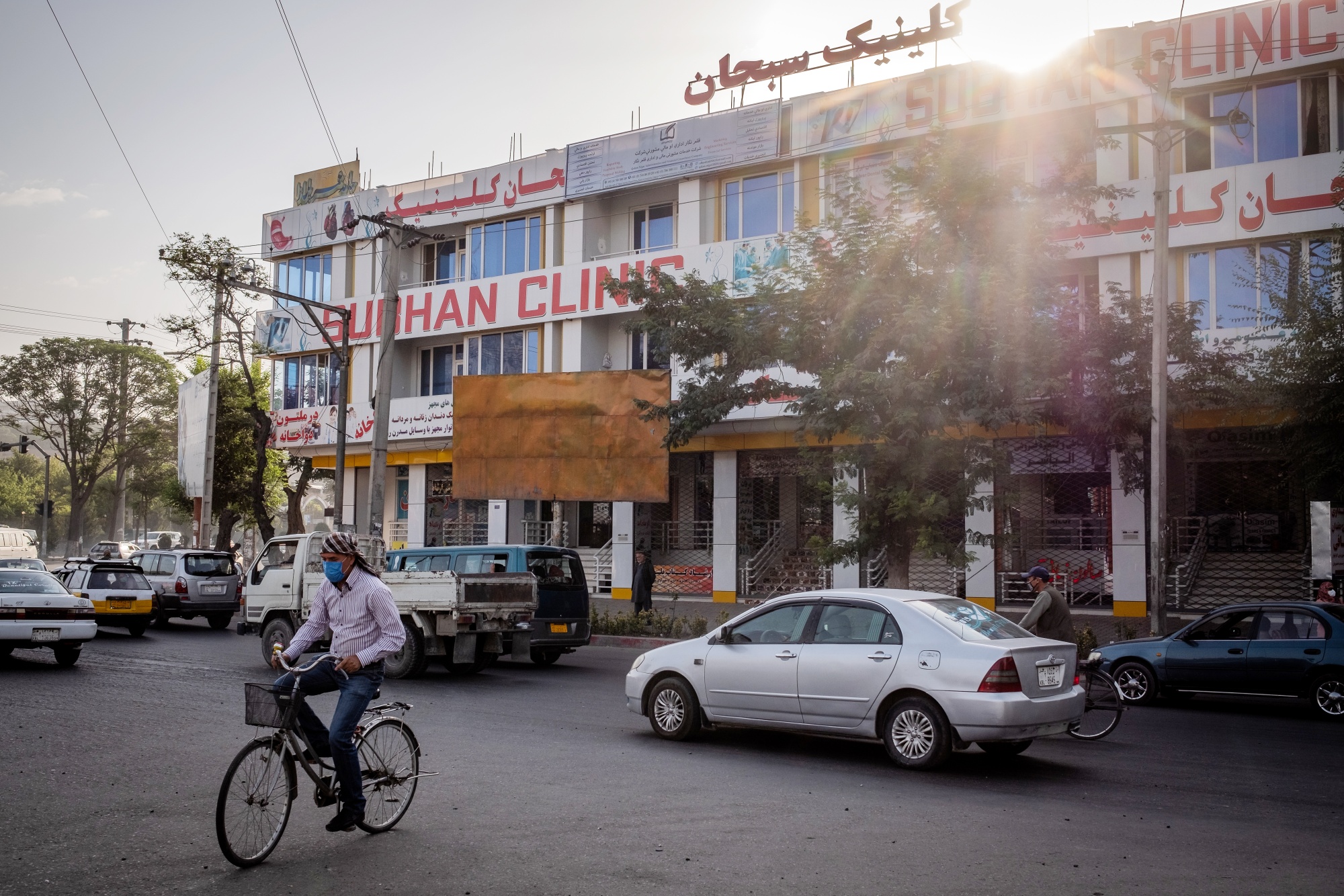 A cyclist rides&nbsp;past the Subhan Clinic in Kabul, which the Afghan&nbsp;health ministry shut&nbsp;for selling its own anti-coronavirus medicine without a valid license