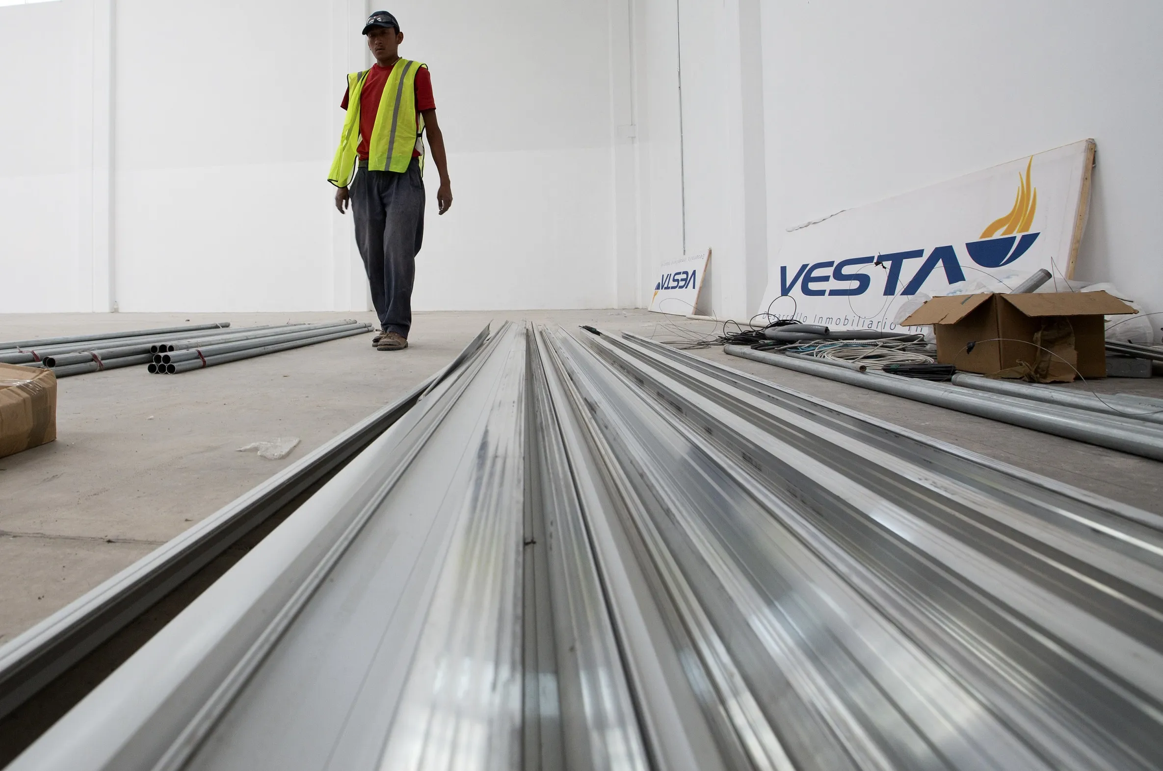 A worker walks inside a warehouse under construction at Corp. Inmobiliaria Vesta SAB’s Aerospace Park in Queretaro, Mexico, in 2013.