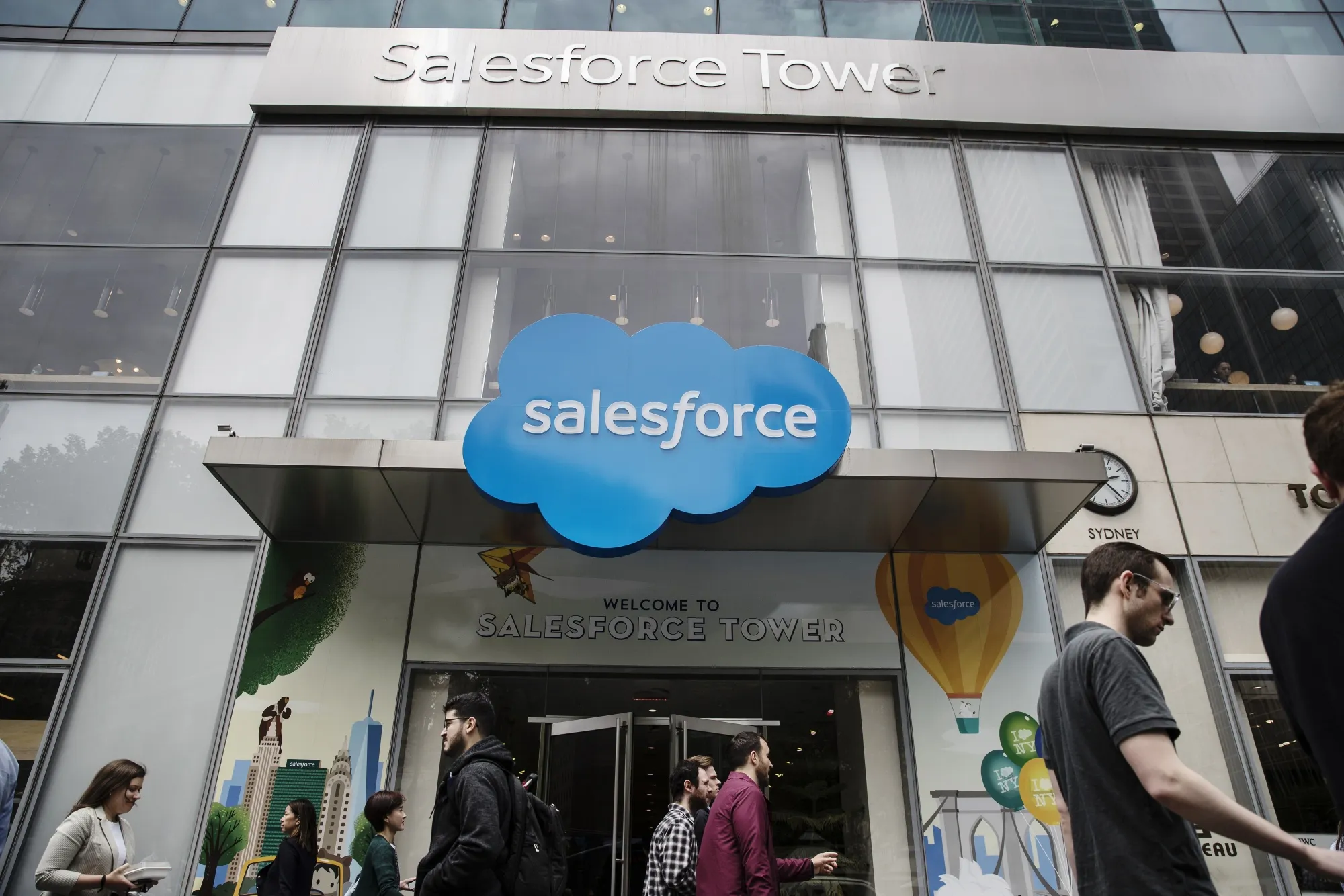Pedestrians pass in front of the Salesforce Tower in New York.