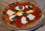 A tomato, mozzarella and basil pizza.