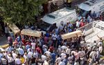 Coffins are carried at the site of an explosion targeting a cultural center in Suruc district of Sanliurfa, Turkey on July 20, 2015.
