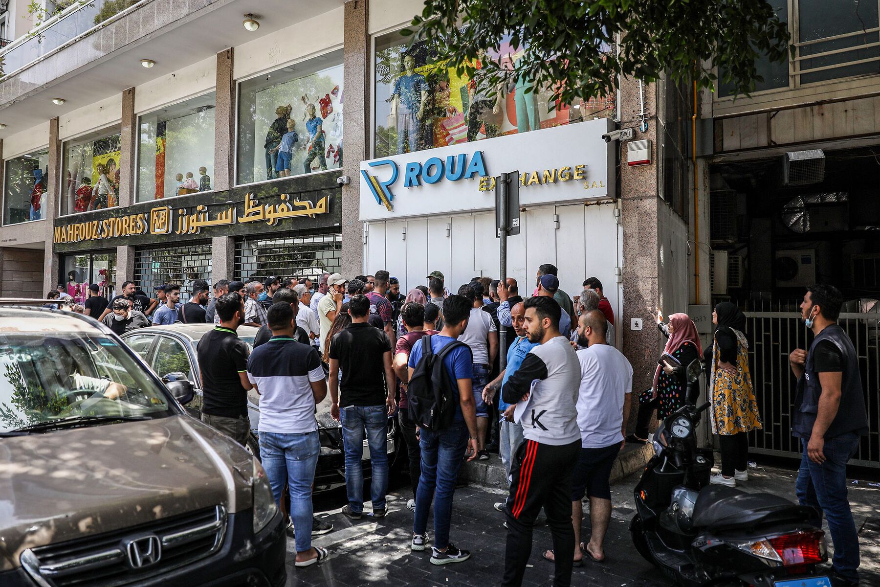Crowds queue outside a currency exchange bureau in Beirut on June 18, 2020. 