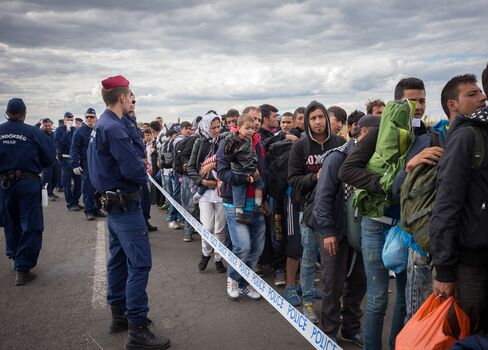 Migrants in Hungary head to a reception camp