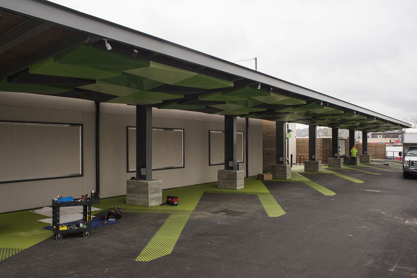 Workers clean up at one of Amazon’s new drive-through grocery pick-up locations.