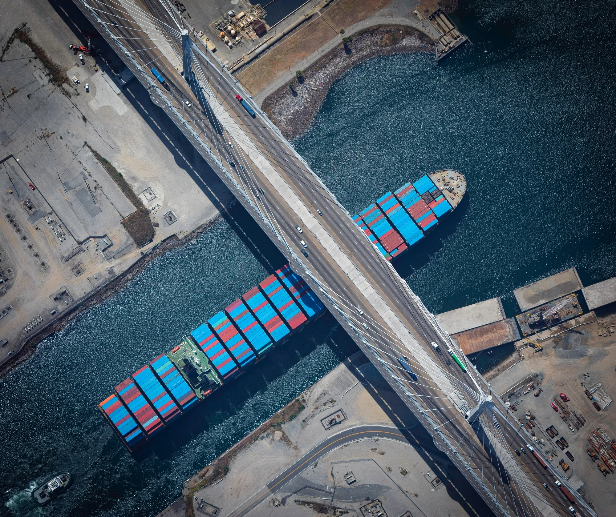 A container ship passes under the International Gateway Bridge at the Port of Long Beach.