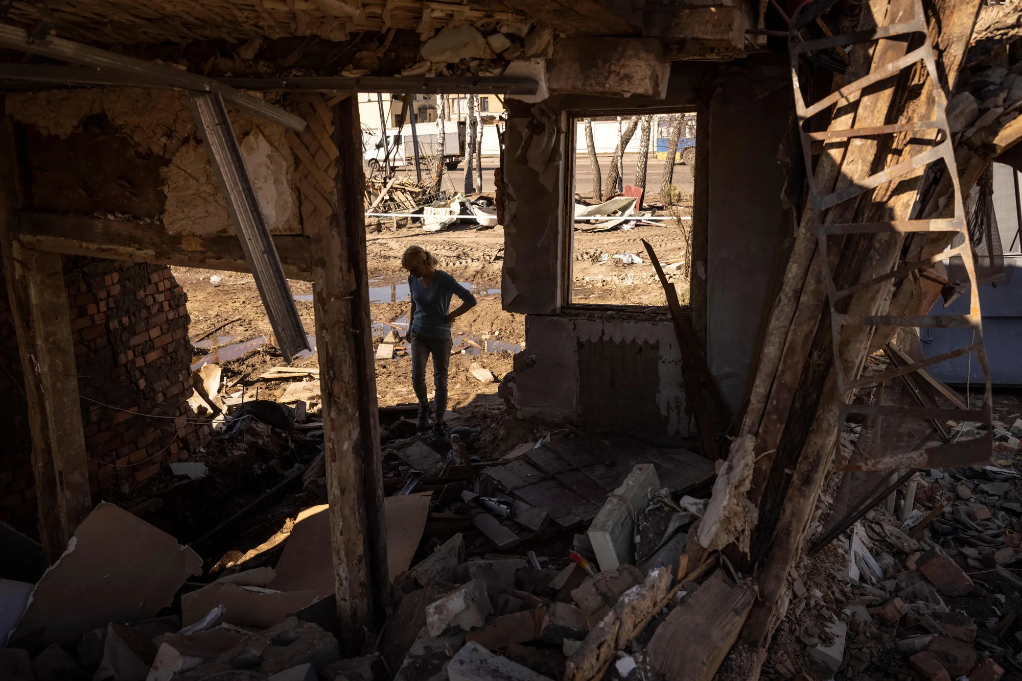 A resident stands among the rubble of her damaged home in Zhytomyr, northern Ukraine, on March 23.
