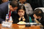 Rizal Commercial Banking Corporation Branch Manager Maia Santos Deguito receives advice from her lawyers during the Senate hearing on March 15.
