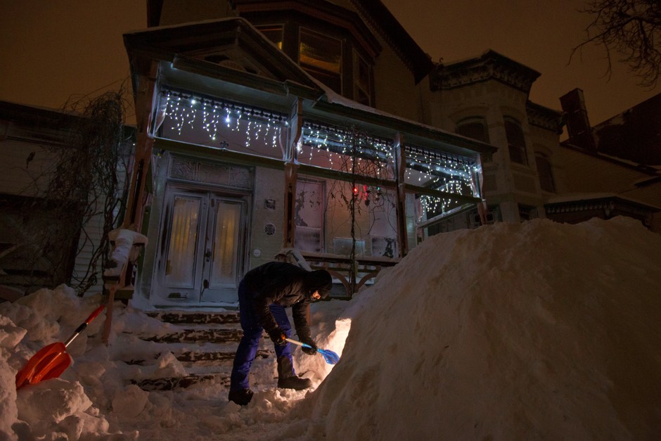 A Buffalo, New York, resident digs a fort during a winter snow storm.