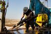 A worker prepares to lift drills by pulley to the main floor of Endeavor Energy Resources LP's Big Dog Drilling Rig 22 in the Permian basin outside of Midland, Texas.
