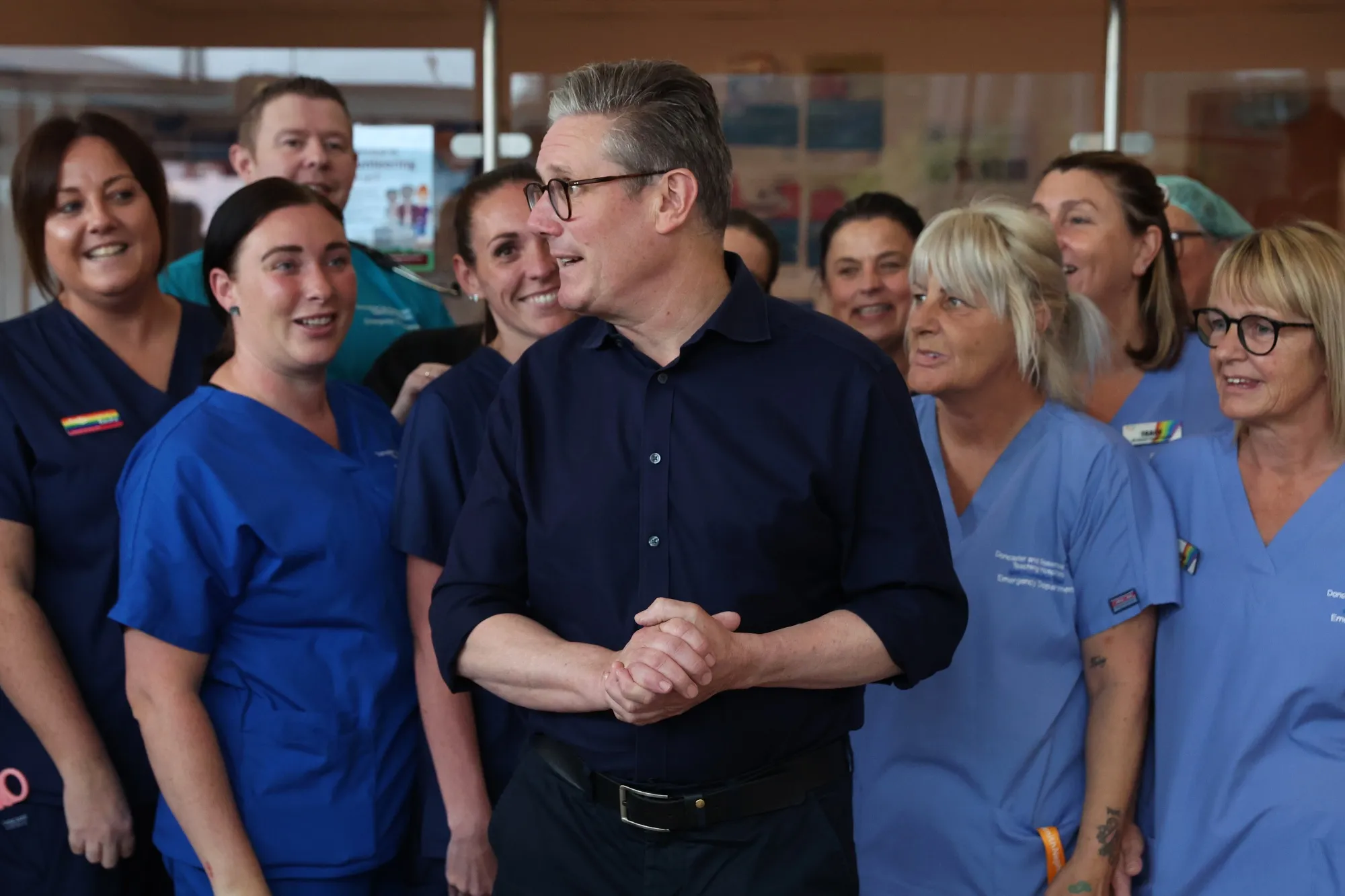 Keir Starmer poses with staff as he visits Bassetlaw Hospital Nottinghamshire in Worksop, England, on June 15.