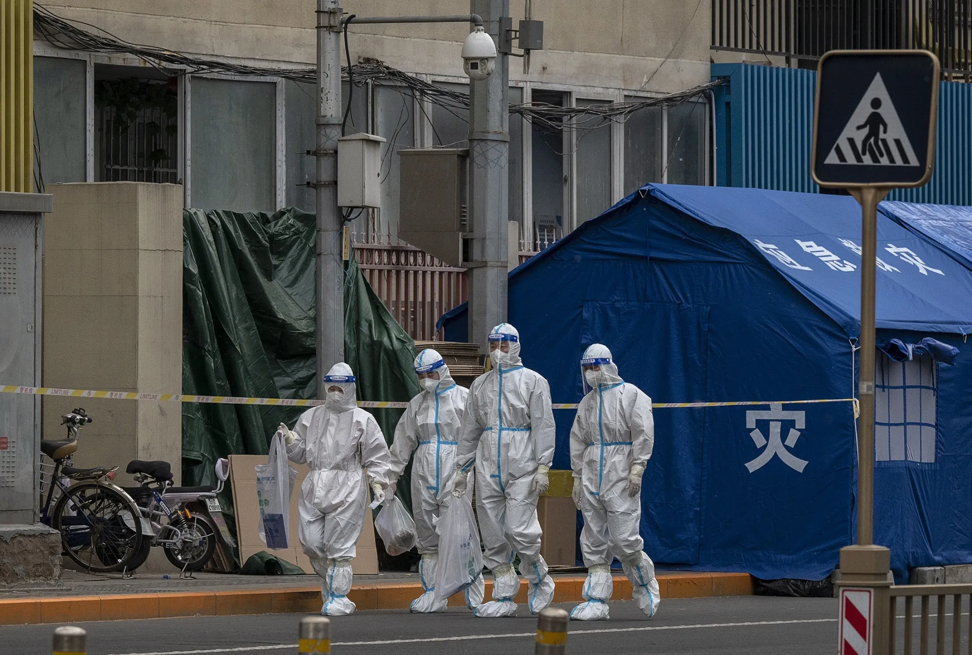 Workers&nbsp;outside a community under lockdown&nbsp;in Beijing on May 11.&nbsp;