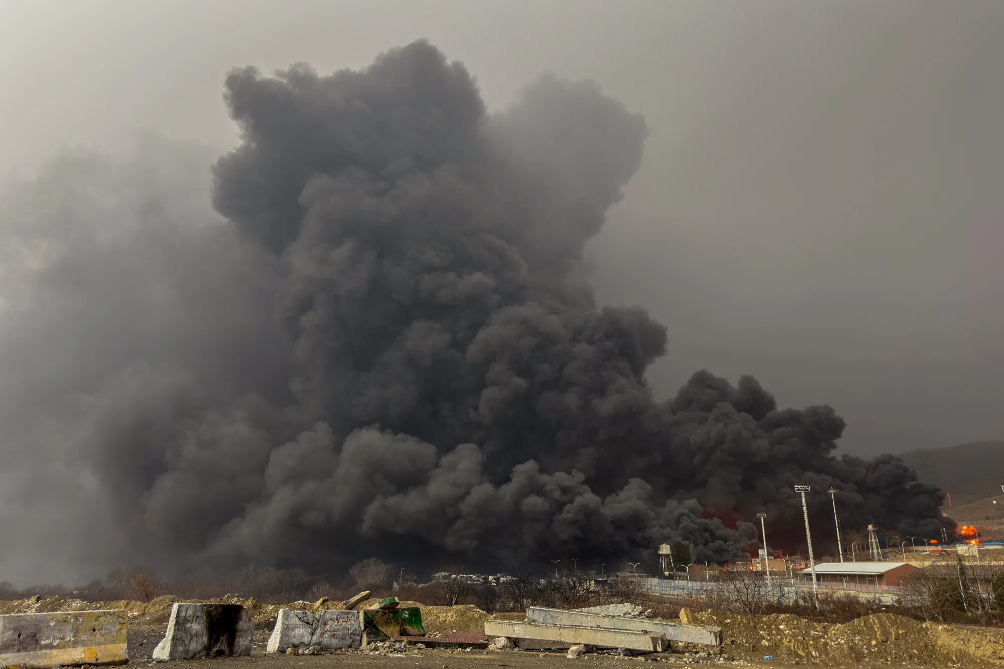 Smoke and flames rise at the site of airstrikes on an oil depot in Tehran on March 8.