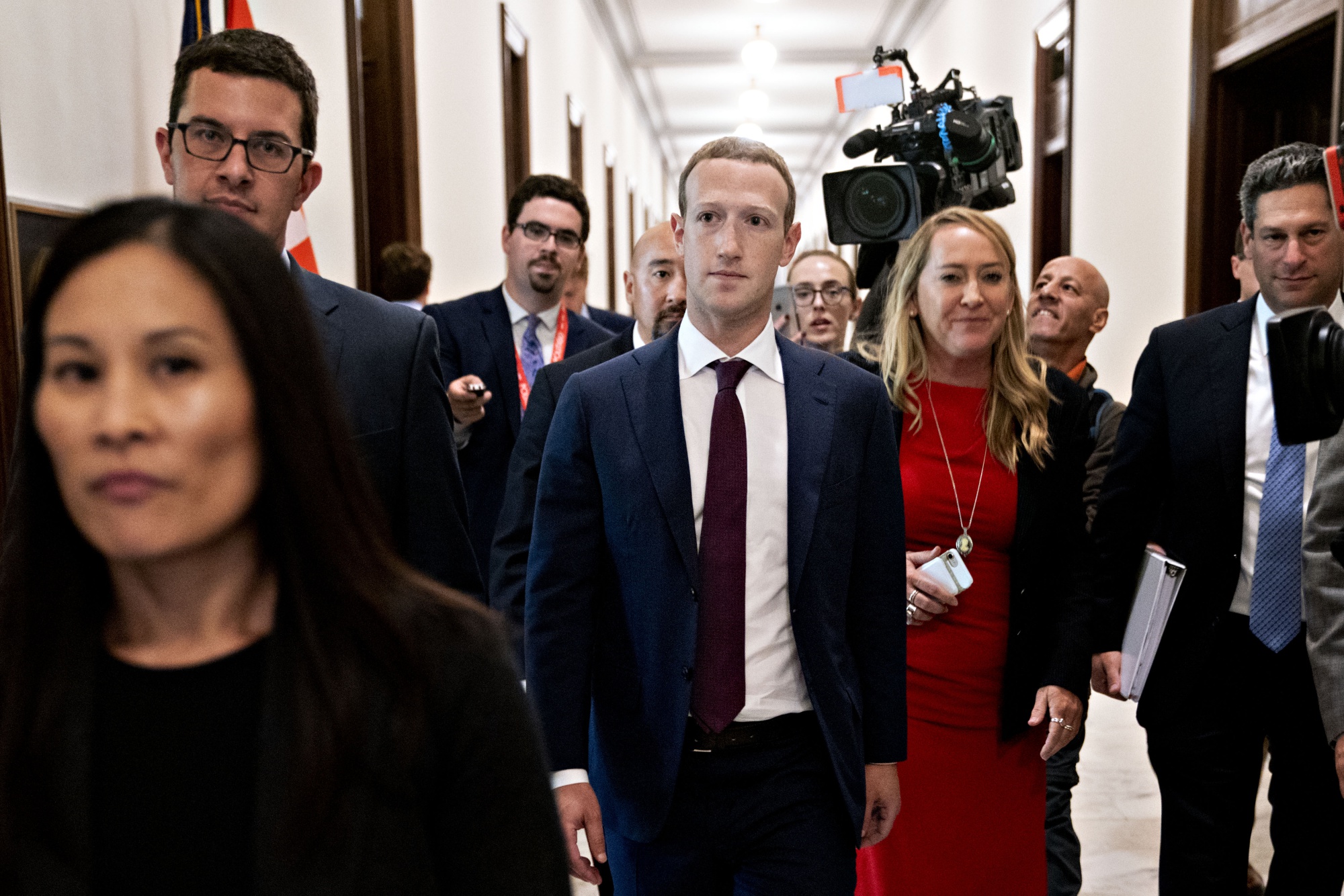 Mark Zuckerberg, center, walks through the Russell Senate Office building in Washington on Sept. 19.