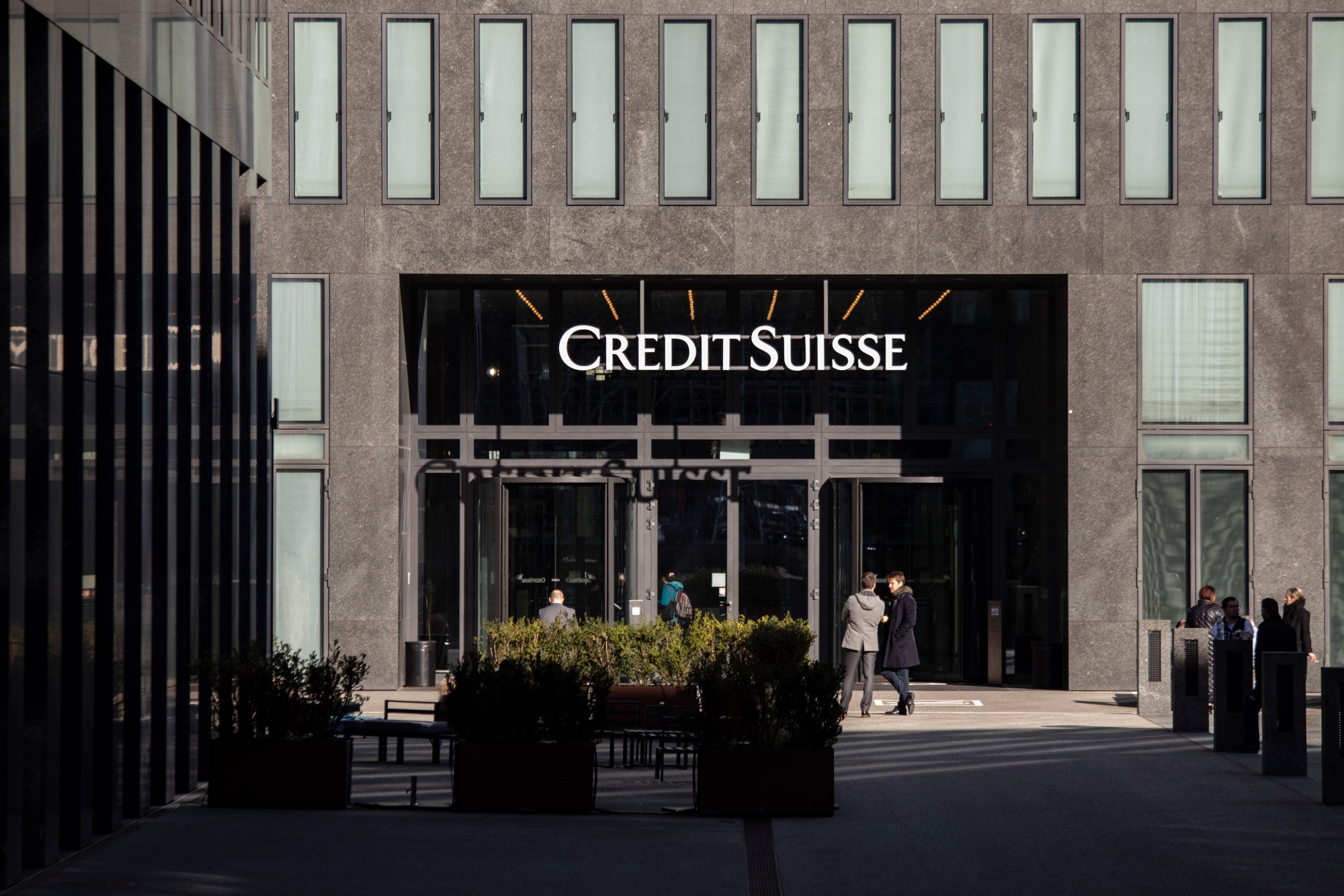 Office workers outside the Credit Suisse Group office tower in Zurich, Switzerland, on Thursday.