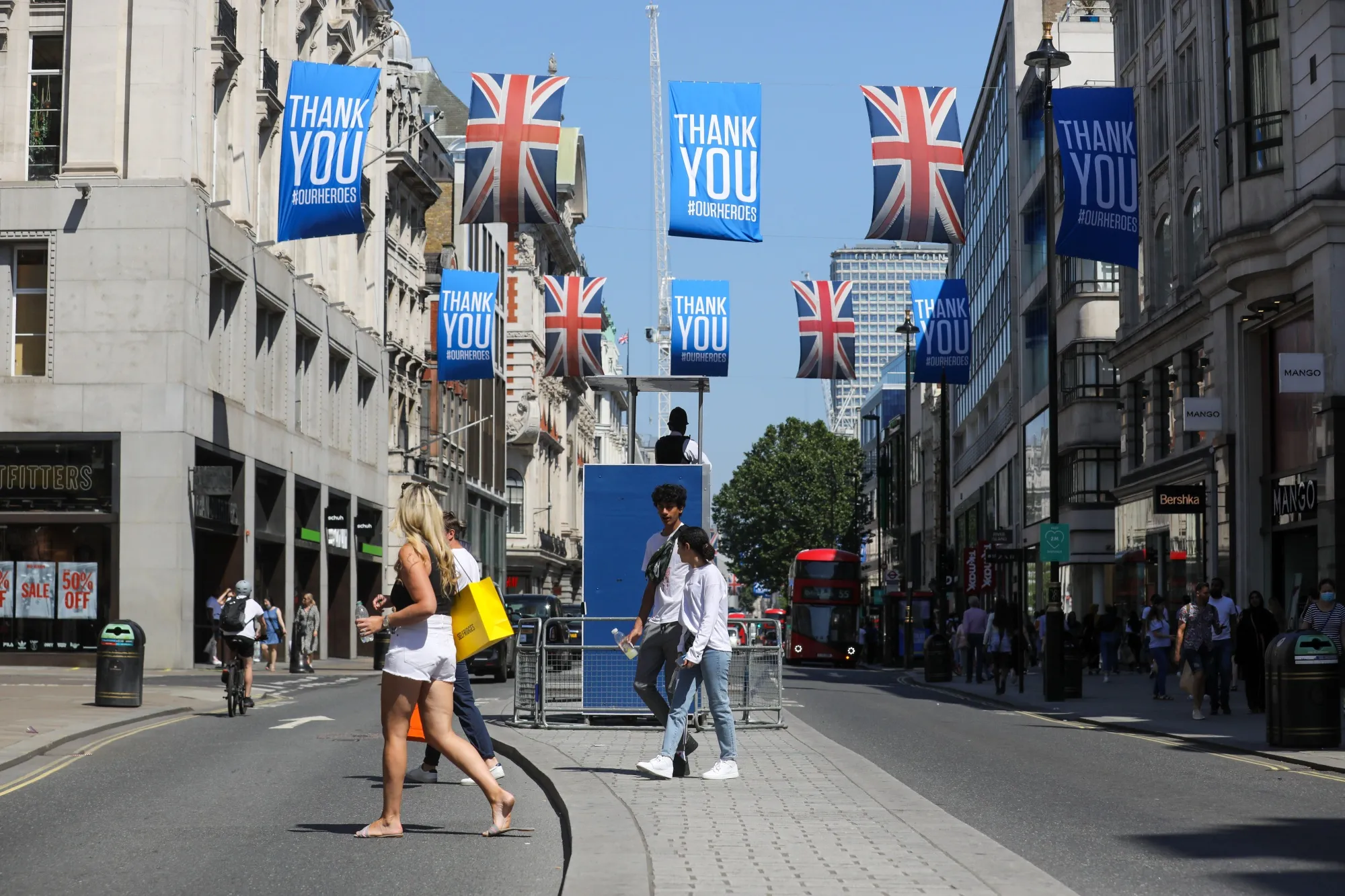 Pedestrians pass beneath British Union flags&nbsp;on Oxford Street in central London.