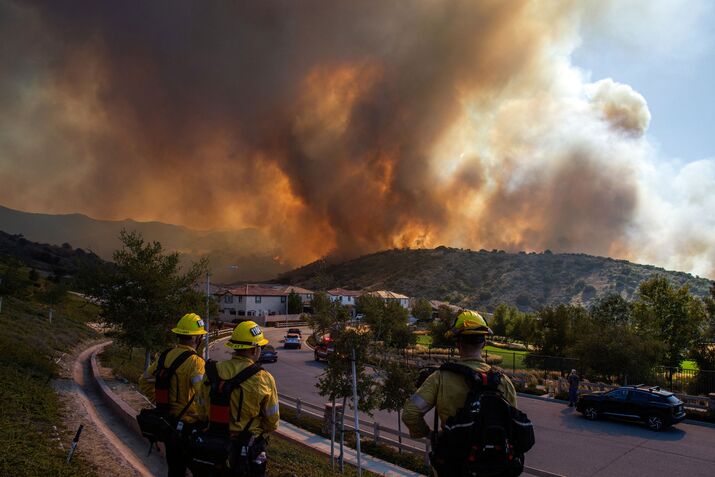 Firefighters near the Sandy Fire as it burns in the hills in Simi Valley, California, on May 18.
