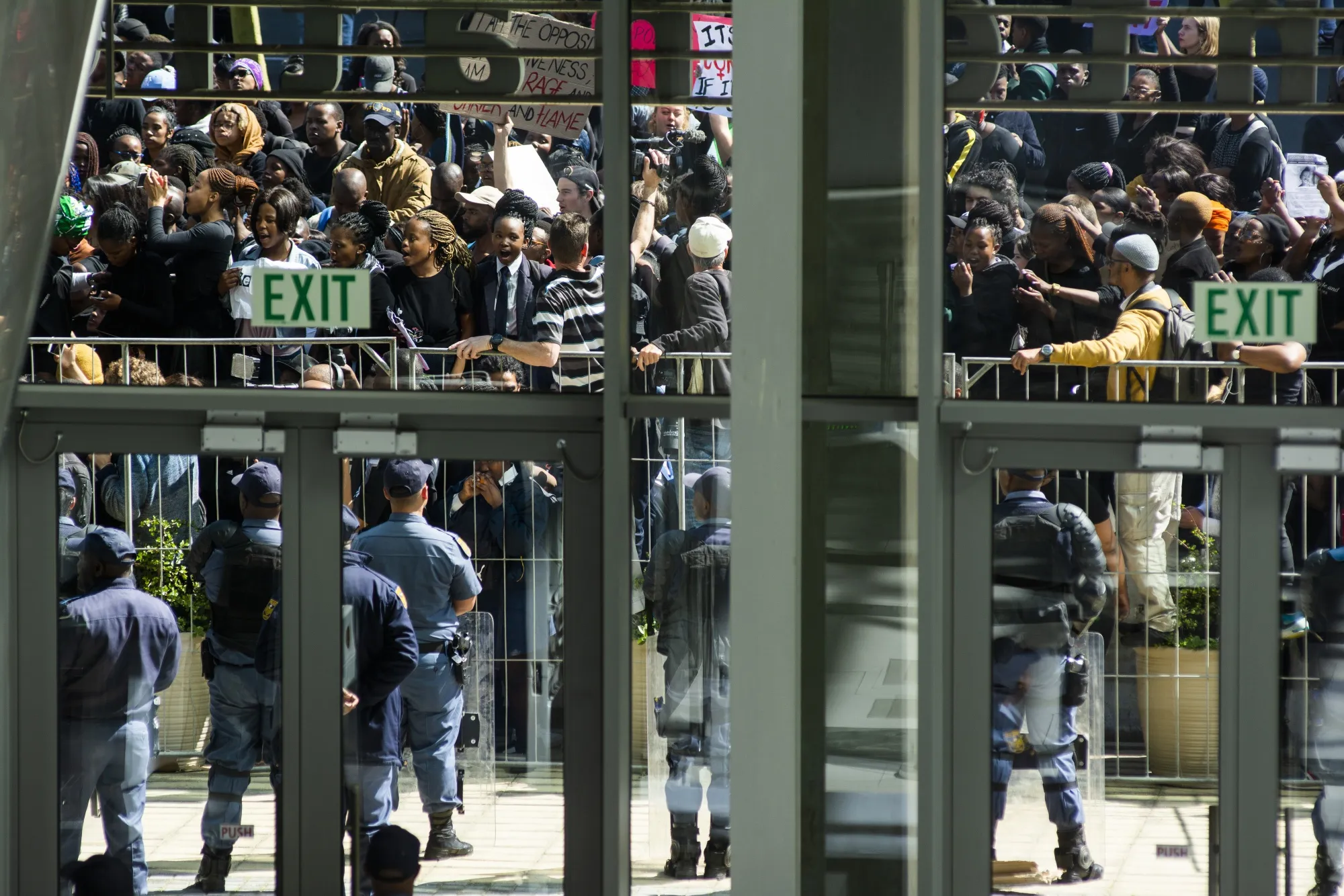 Security guards stand on patrol as protestors gather outside the the Cape Town International Convention Centre on Sept. 4.