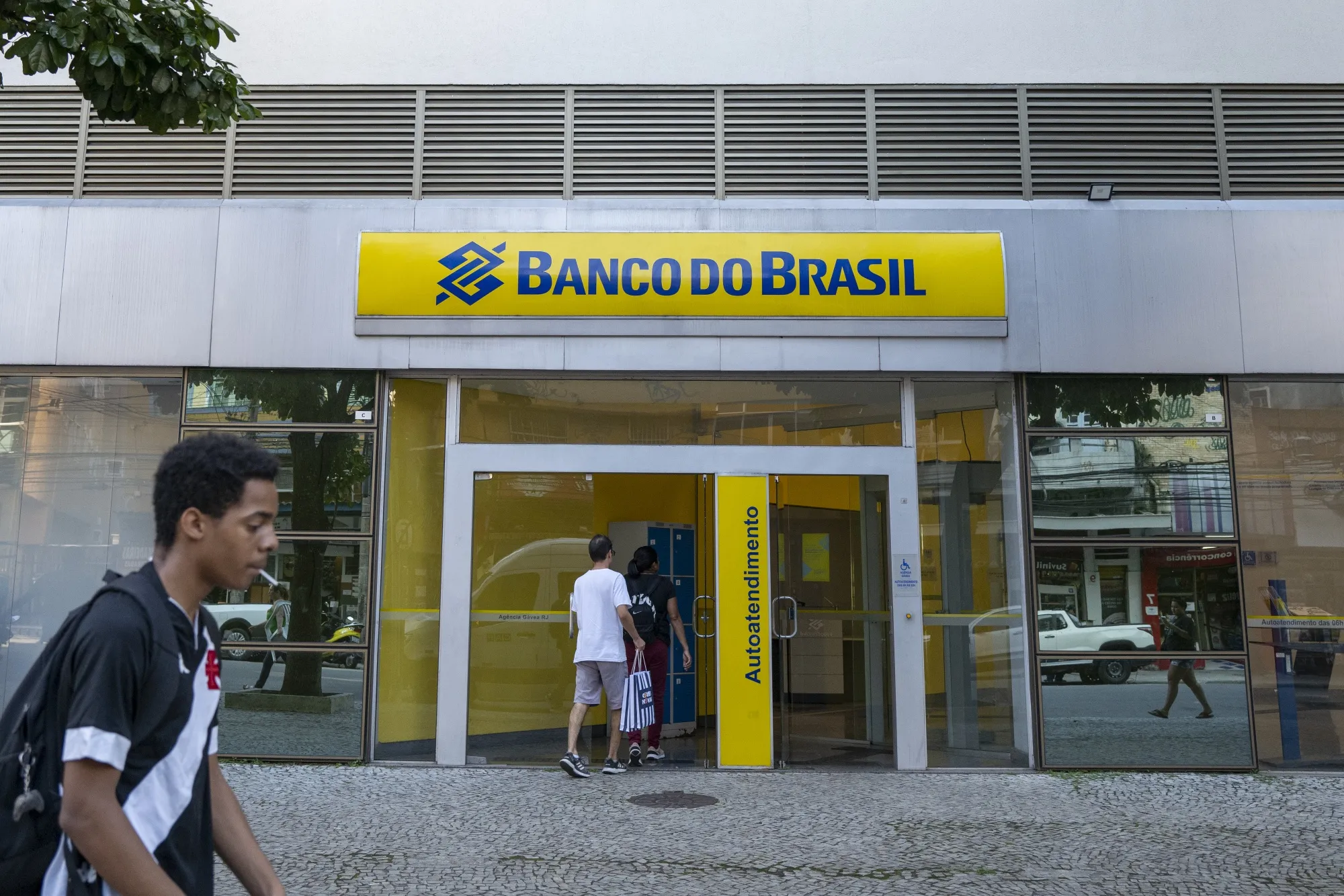 Customers enter a Banco do Brasil branch in Rio de Janeiro.