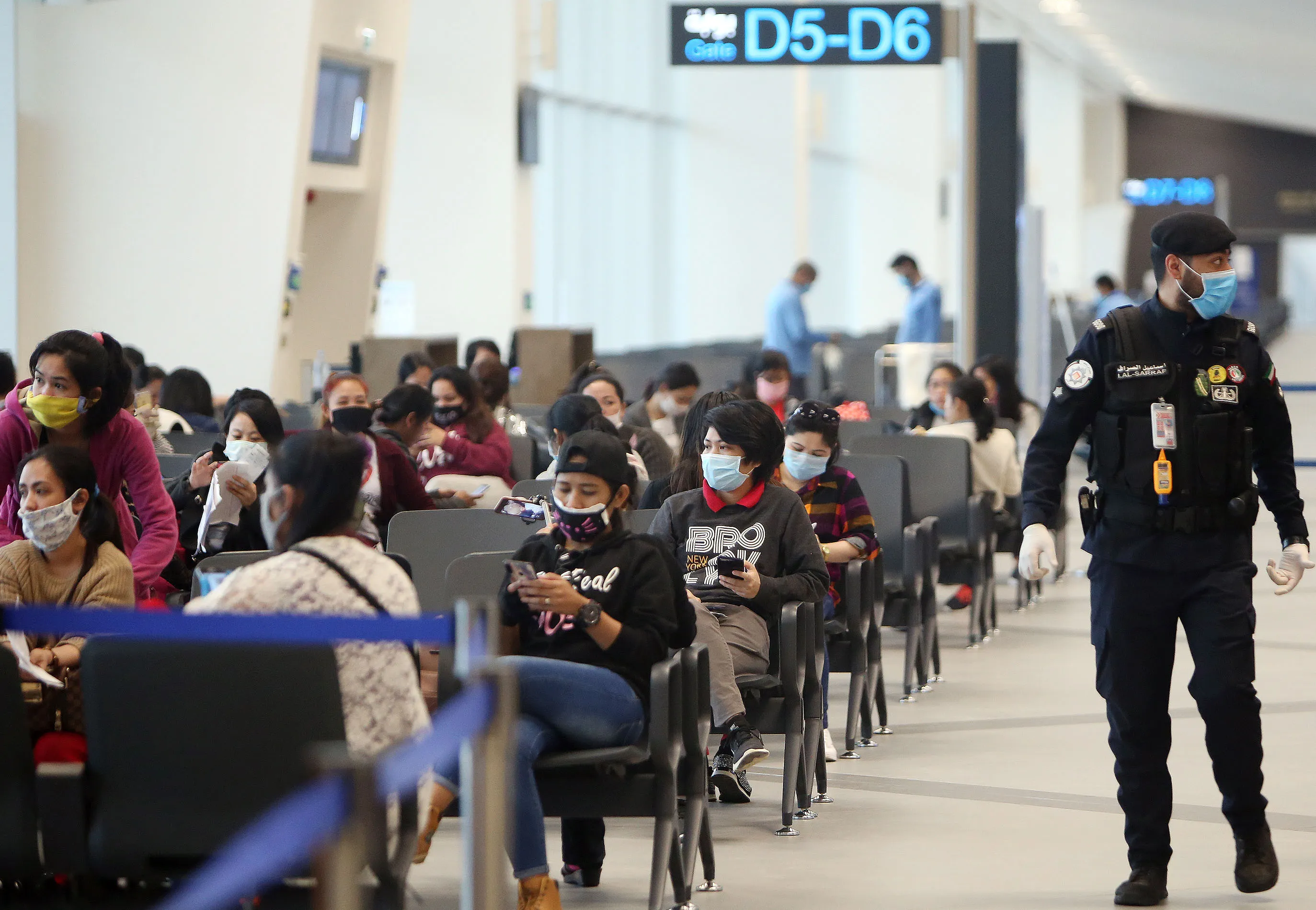 Filipinos who availed general amnesty granted by the Kuwaiti government wait for their return flight to the Philippines at the Kuwait International Airport, on April 3.