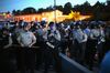 Police stand watch as demonstrators protest the shooting death of teenager Michael Brown in Ferguson, Missouri.
