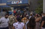 Residents line up in front of a bank to receive government aid in Juazeiro do Norte, Ceara state