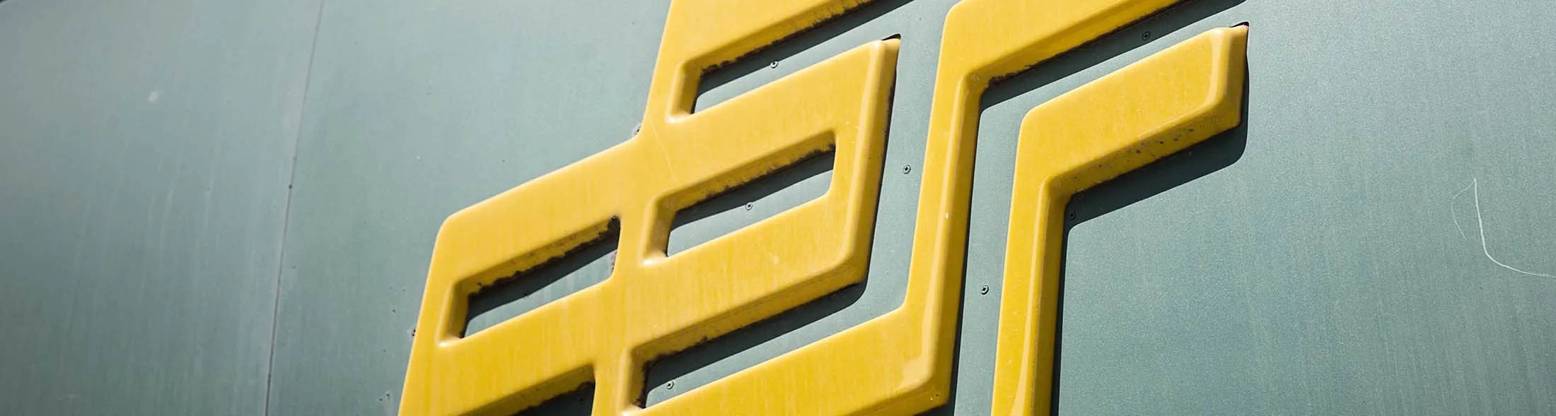 The logo for Postal Savings Bank of China Co. is displayed outside a bank branch in Shanghai, China, on Monday, July 4, 2016. Postal Savings Bank, China's sixth largest in terms of assets, is seeking to raise $8 billion in what could be the world's largest IPO this year, according to people familiar with the matter.
