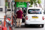 A customer fills their taxi at a Texaco Inc. petrol station in London.