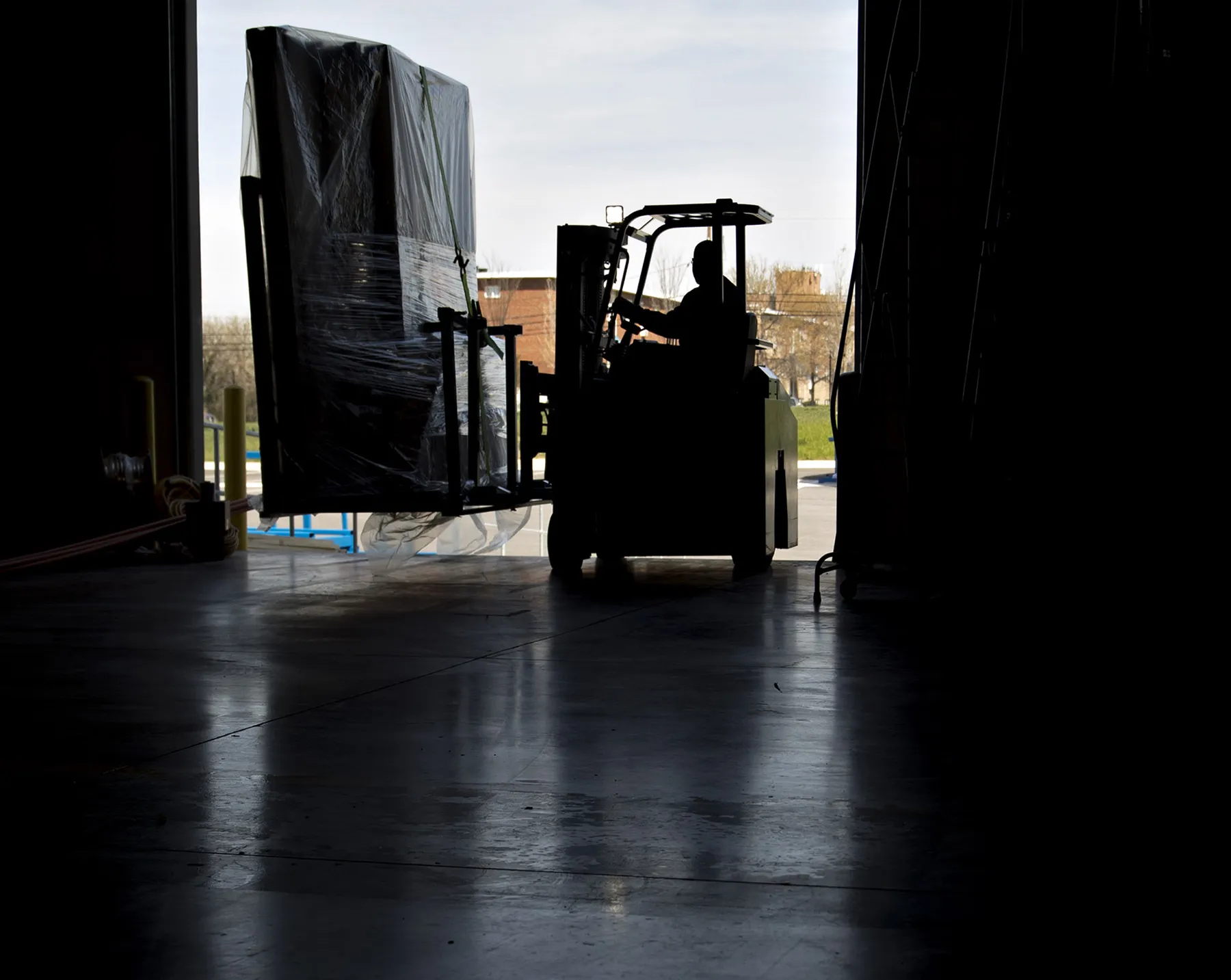 An employee moves an order of walls on a forklift at the Blueprint Robotics facility in Baltimore.