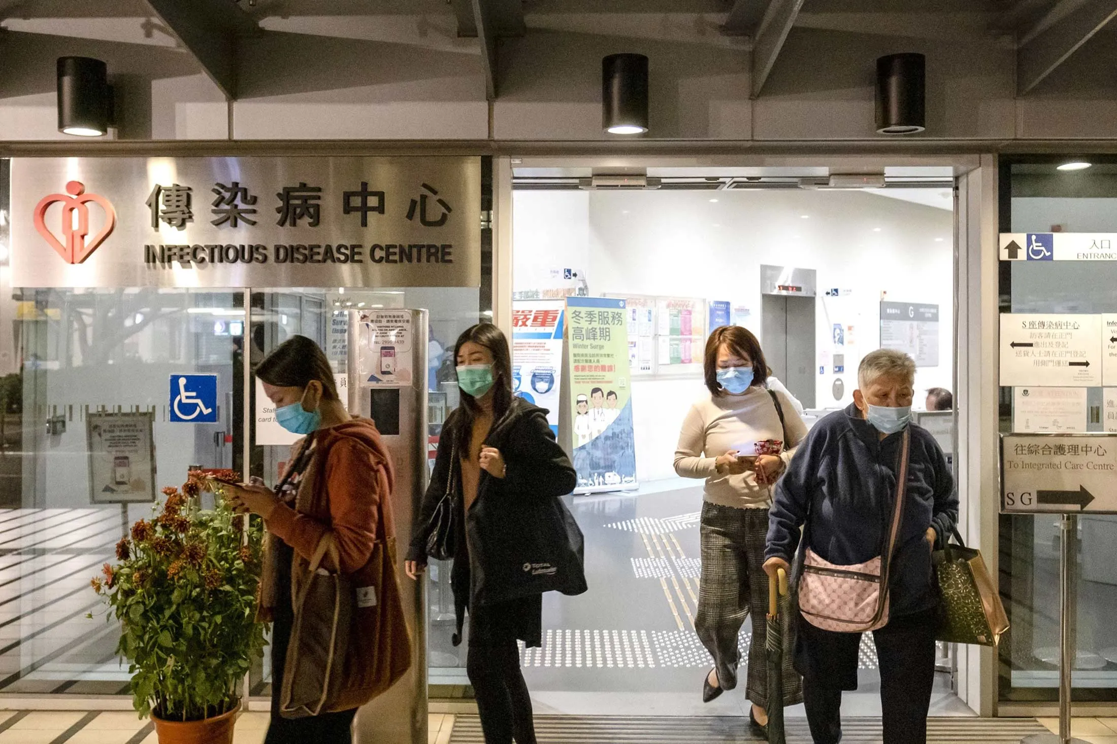 People wearing face masks exit the Infectious Disease Centre at Princess Margaret Hospital in Hong Kong, China.