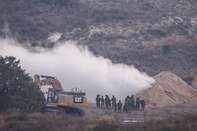 Israeli soldiers spray gas at a tunnel used by Hamas militants to infiltrate Israeli lines.
