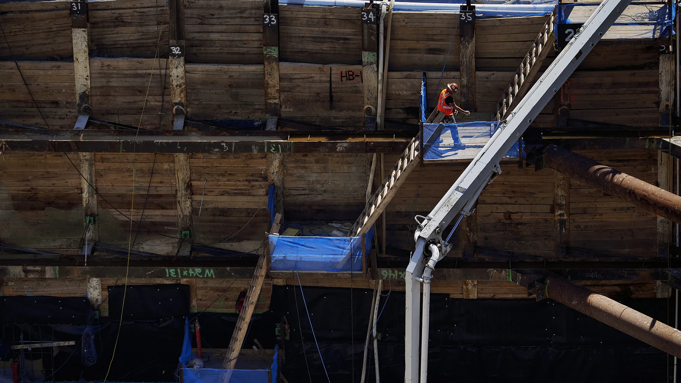 Contractors work at the site of the new Fannie Mae headquarters under construction in Washington, D.C., U.S., on Wednesday, Aug. 17, 2016. The hole at the corner of 15th and L streets, in downtown Washington, is deep -- and getting deeper. Earth-movers there are digging the foundations of a shiny new headquarters for Fannie Mae, the bailed-out giant of American mortgages.
