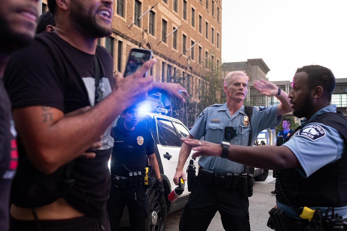 Minneapolis police officers control a crowd of protesters on Aug. 26. 
