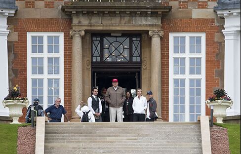 Donald Trump stands outside Trump Turnberry Resort Hotel Golf