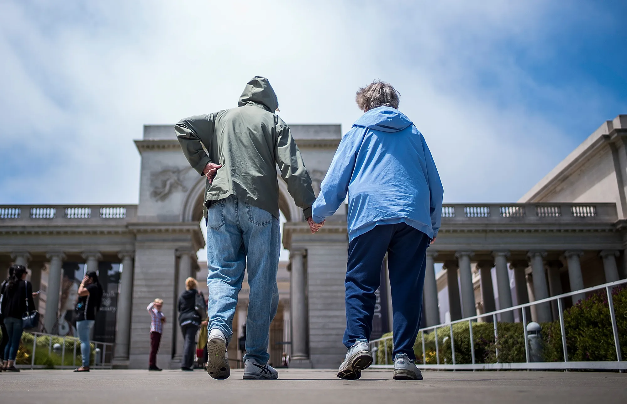 An elderly couple walks in San Francisco.
