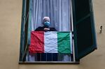 A man watches from his balcony in the San Basilio suburbs of Rome.