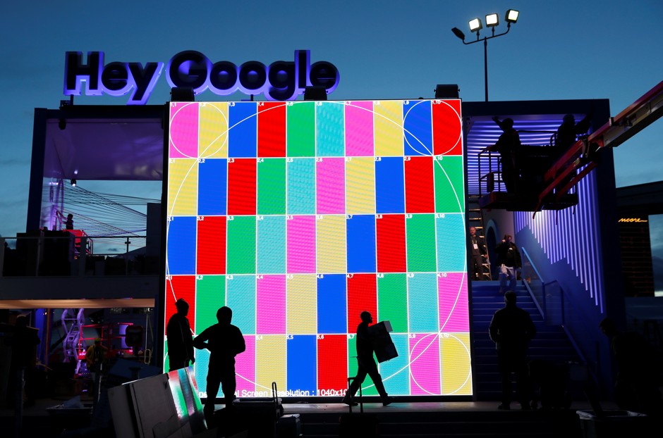 Technicians work on a &quot;Hey Google&quot; booth in front of the Las Vegas Convention Center, in advance of CES.
