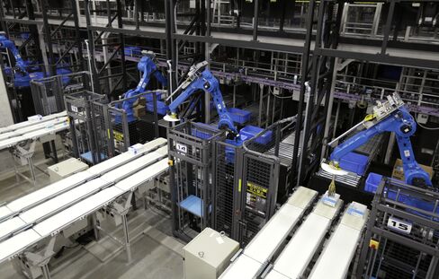Industrial robots sort items at a distribution center in Kuki, Japan