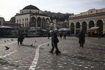 A street cleaner walks across Monastiraki square in Athens, Greece, on Thursday, Feb. 9, 2017. Greece is back in the headlines as it struggles to free itself from a disagreement between the International Monetary Fund and Europe.

