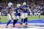Indianapolis Colts outside linebacker Darius Leonard (53) celebrates along with teammates Kenny Moore II (23) and Khari Willis after intercepting a pass during the first half of an NFL football game against the New England Patriots Saturday, Dec. 18, 2021, in Indianapolis. (AP Photo/Aaron Doster)