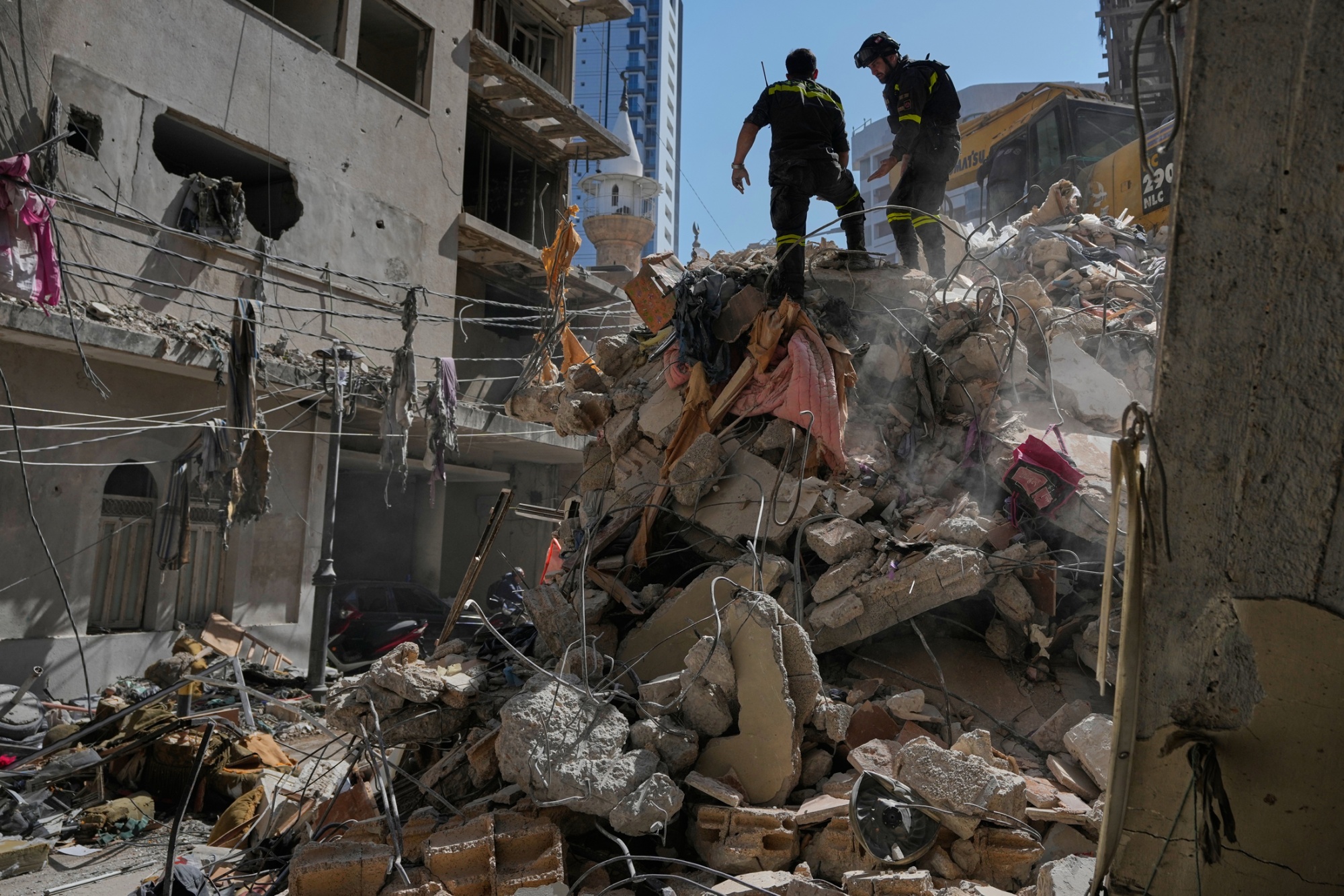 Civil defense workers inspect the site of an Israeli airstrike in Beirut, on April 9.