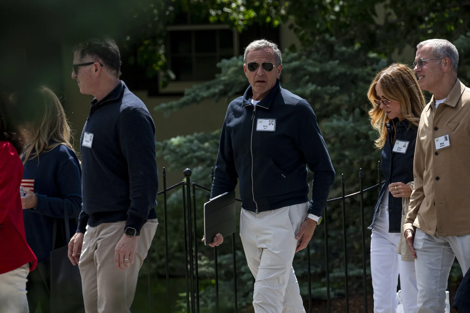 Michael Dell, chairman and chief executive officer of Dell Inc., left, and Bob Iger, chief executive officer of Walt Disney Co., center, walk to lunch during the Allen & Co. Media and Technology Conference in Sun Valley, Idaho, US, on Thursday, July 13, 2023. The summit is typically a hotbed for etching out mergers over handshakes, but could take on a much different tone this year against the backdrop of lackluster deal volume, inflation and higher interest rates.