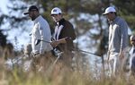 Norway's Viktor Hovland, center, and Spain's Jon Rahm, left, during day one of the Scottish Open at The Renaissance Club, North Berwick, Scotland, Thursday July 7, 2022. (Steve Welsh/PA via AP)