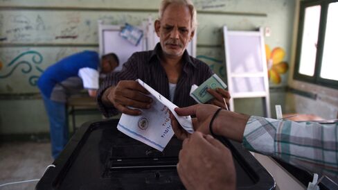 An Egyptian man casts his ballot in the Egyptian parliamentary elections at a polling station in the Giza district of the capital Cairo, on October 18, 2015. Photographer: Mohamed El-Shahed/AFP via Getty Images