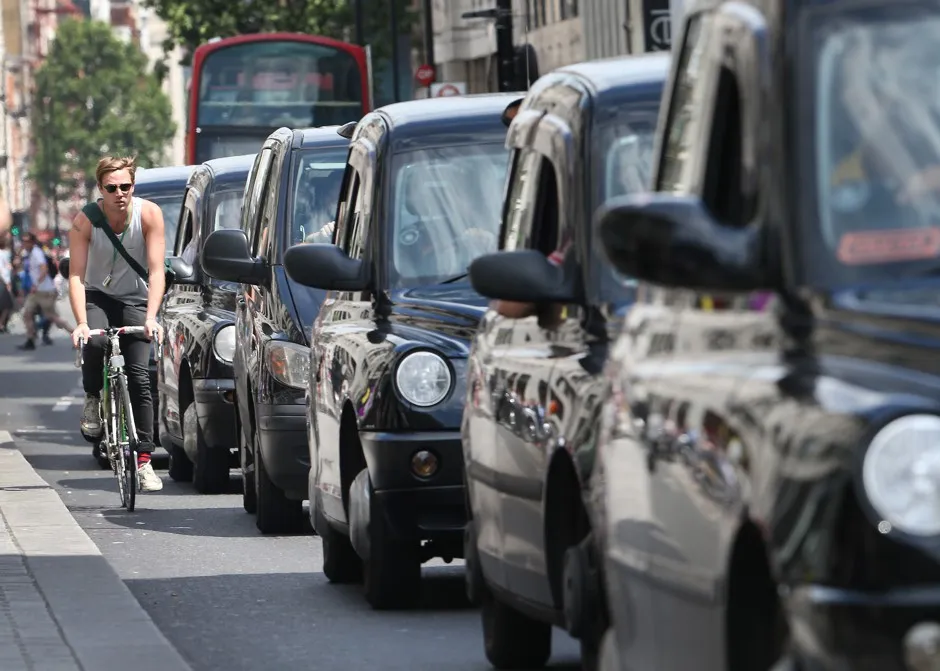 A cyclist in London, where bikes, buses, and cabs are vying for road space.