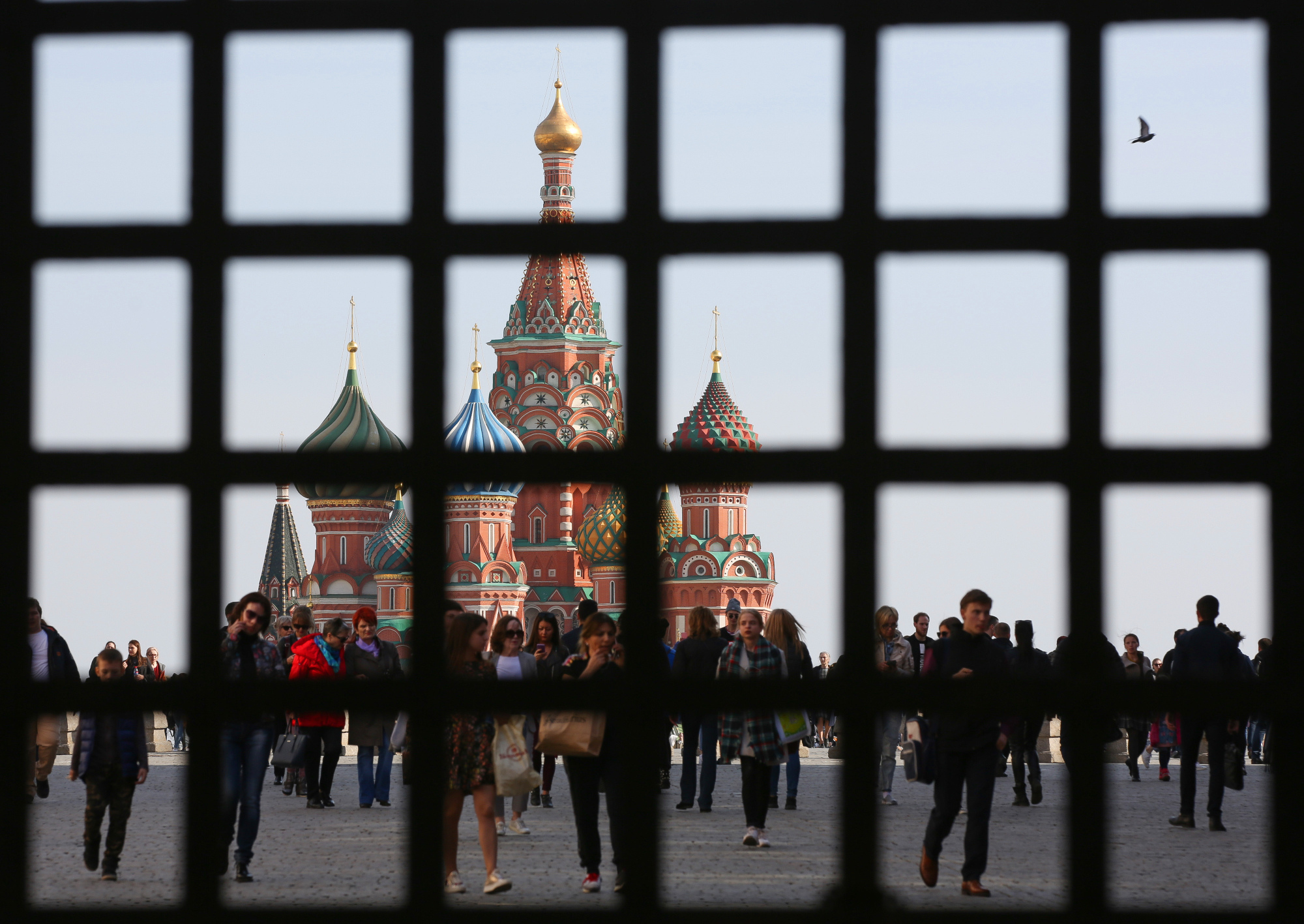 Visitors walk through Red Square near Saint Basil's cathedral in Moscow.