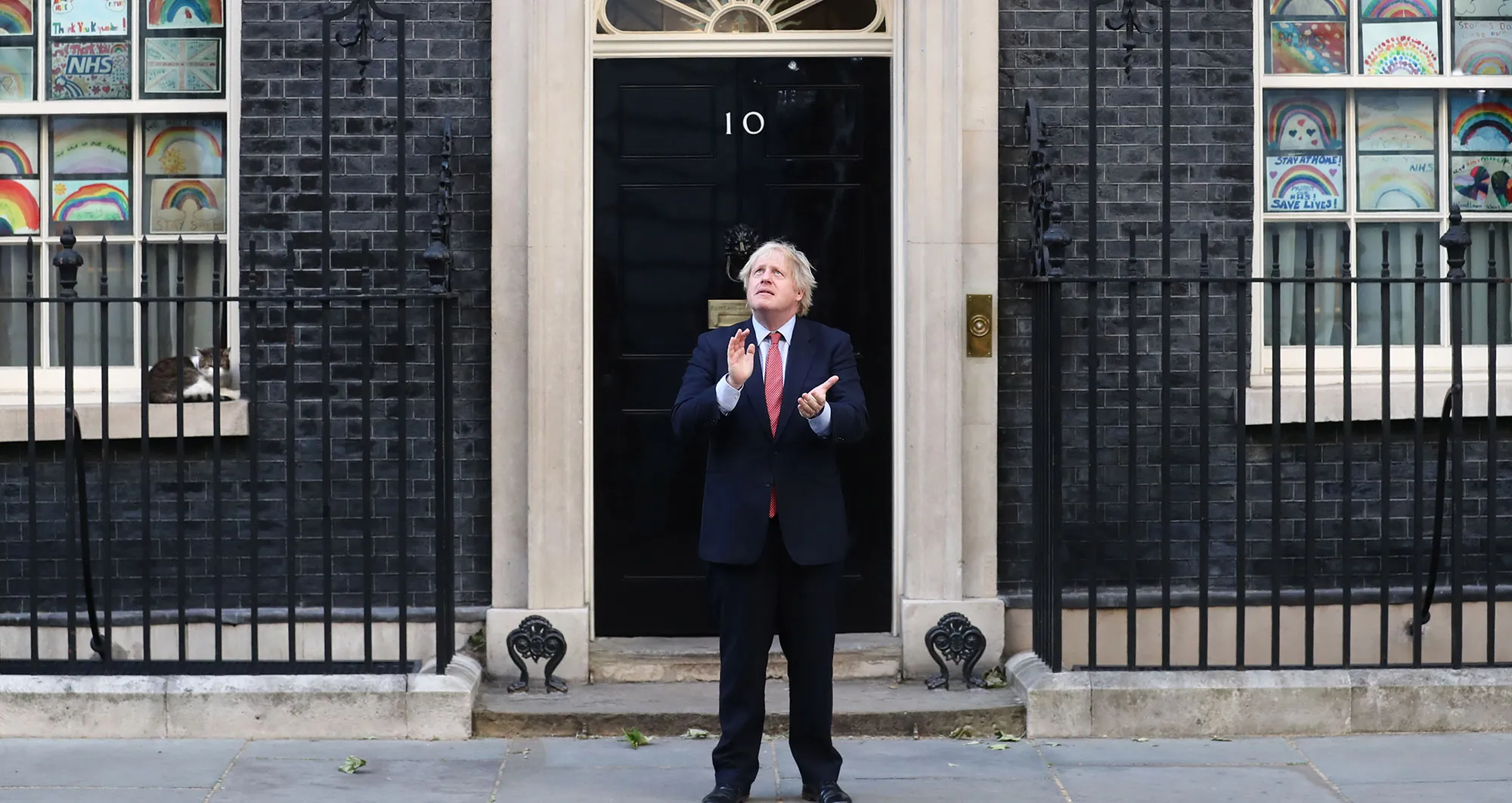 Boris Johnson claps while standing outside number 10 Downing Street during a national round of applause to show appreciation for health workers in London.
