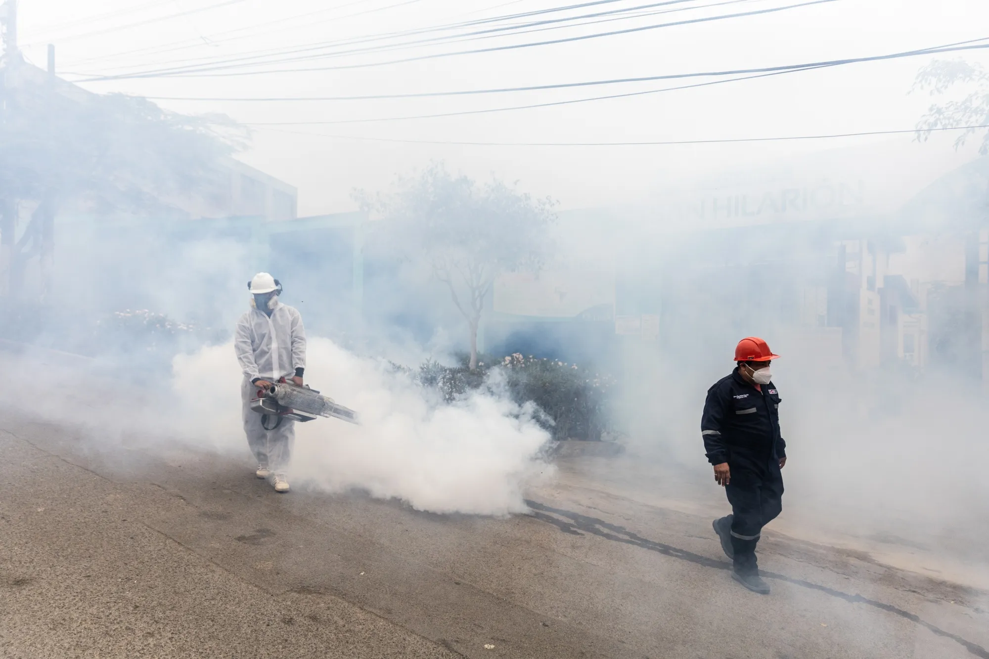 A Ministry of Health worker fumigates against the dengue virus in the San Juan de Lurigancho neighborhood of Lima, Peru, on Friday, May 19, 2023.&nbsp;