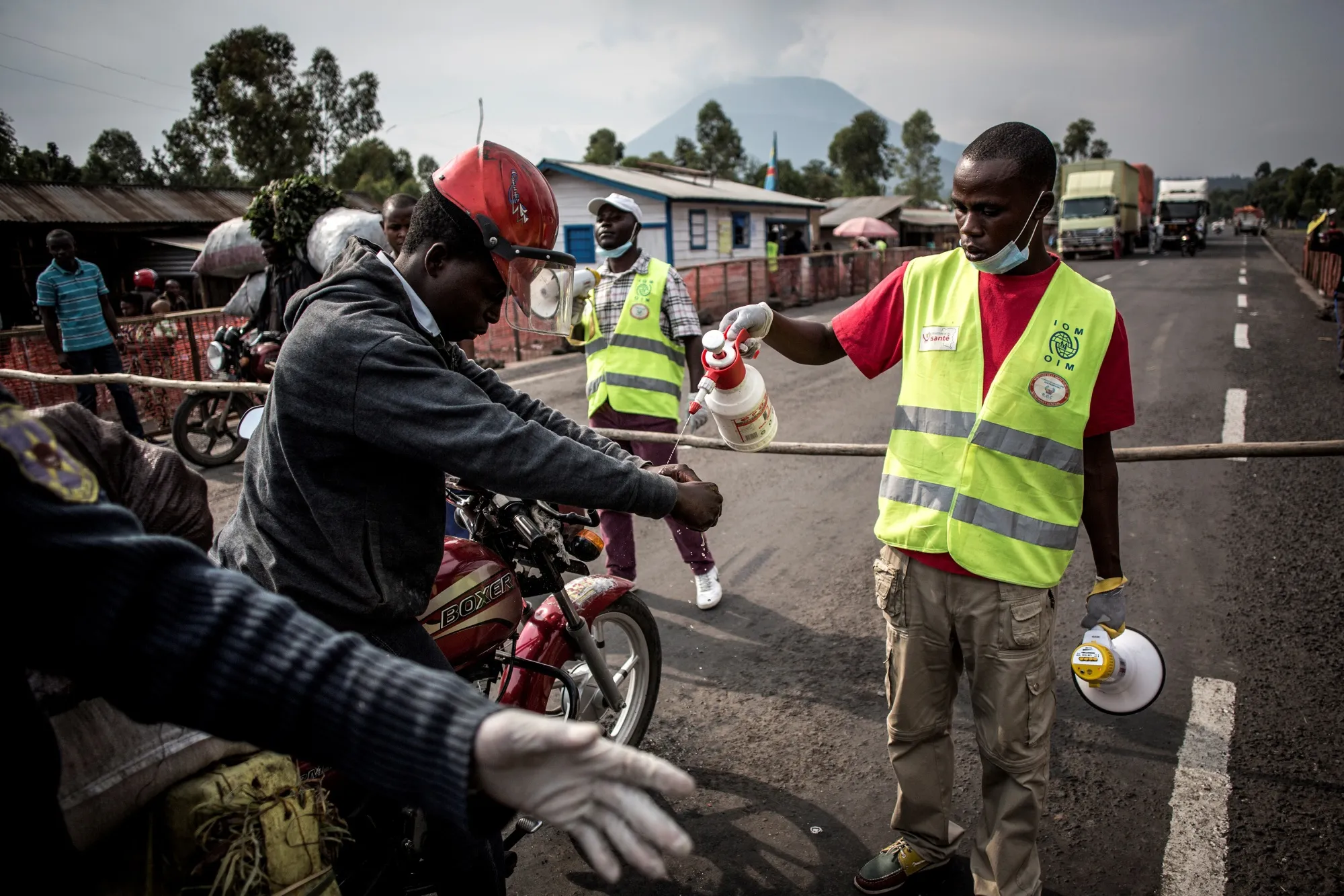 A motor taxi driver gets his hands washed at an Ebola screening station in Goma on July 16.